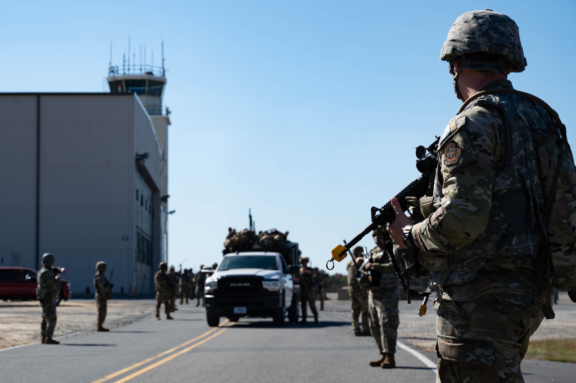 U.S. Air Force Airmen assigned to the 87th Civil Engineer Squadron prepare for a ruck march during Operation Honey Badger at Joint Base McGuire-Dix-Lakehurst, N.J., Oct. 20, 2024. The route was charted prior to departure to move personnel and equipment to the base of operations. (U.S. Air Force photo by Senior Airman Aidan Thompson)