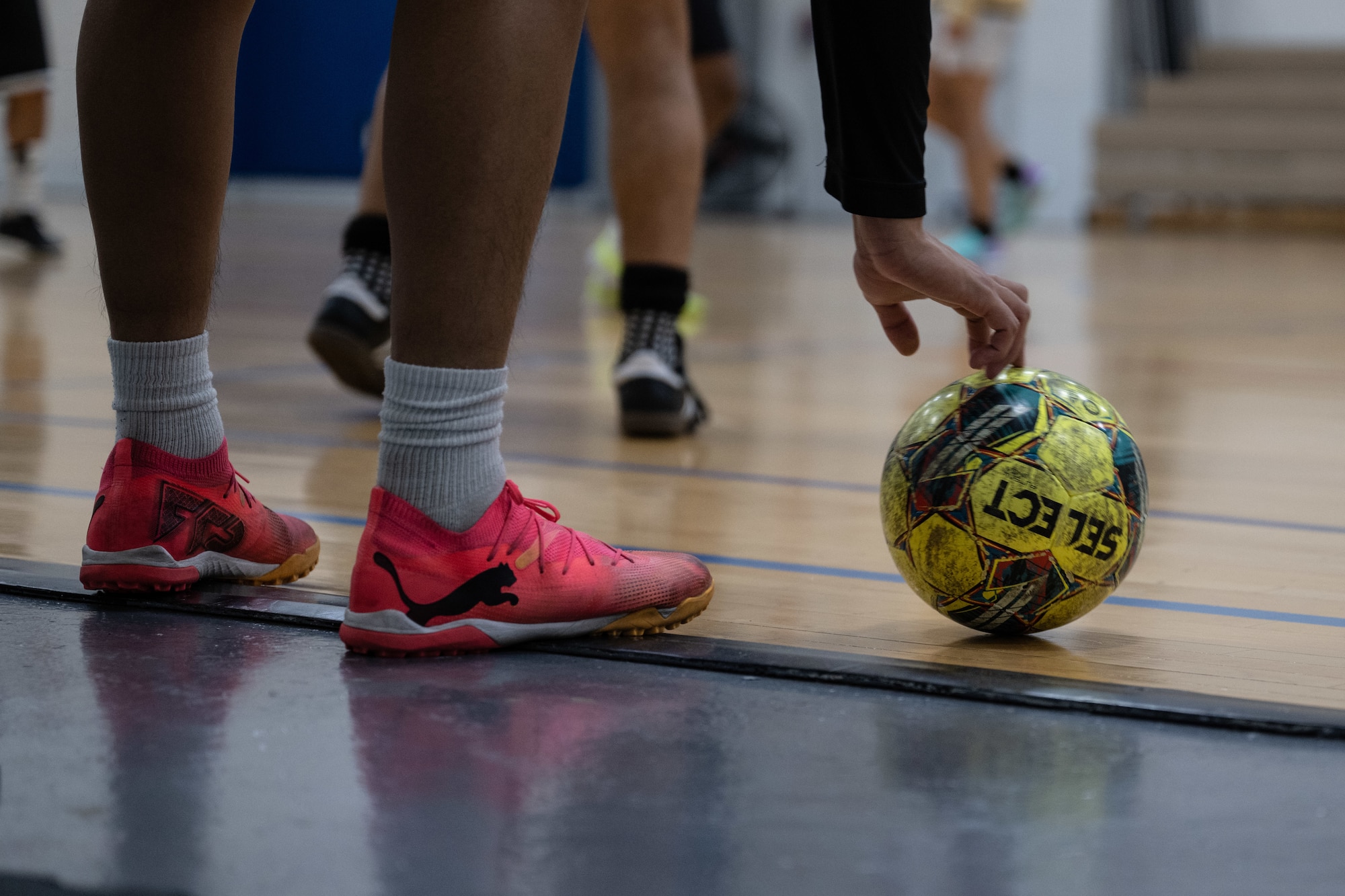 A player prepares to kick the ball as teammates position themselves during a pickup soccer game at Joint Base Andrews, Md., Oct. 17, 2024. Indoor soccer sessions provide a positive outlet for resilience and physical readiness during the colder months, building a stronger Andrews community. (U.S. Air Force photo by Senior Airman Martha Moore)