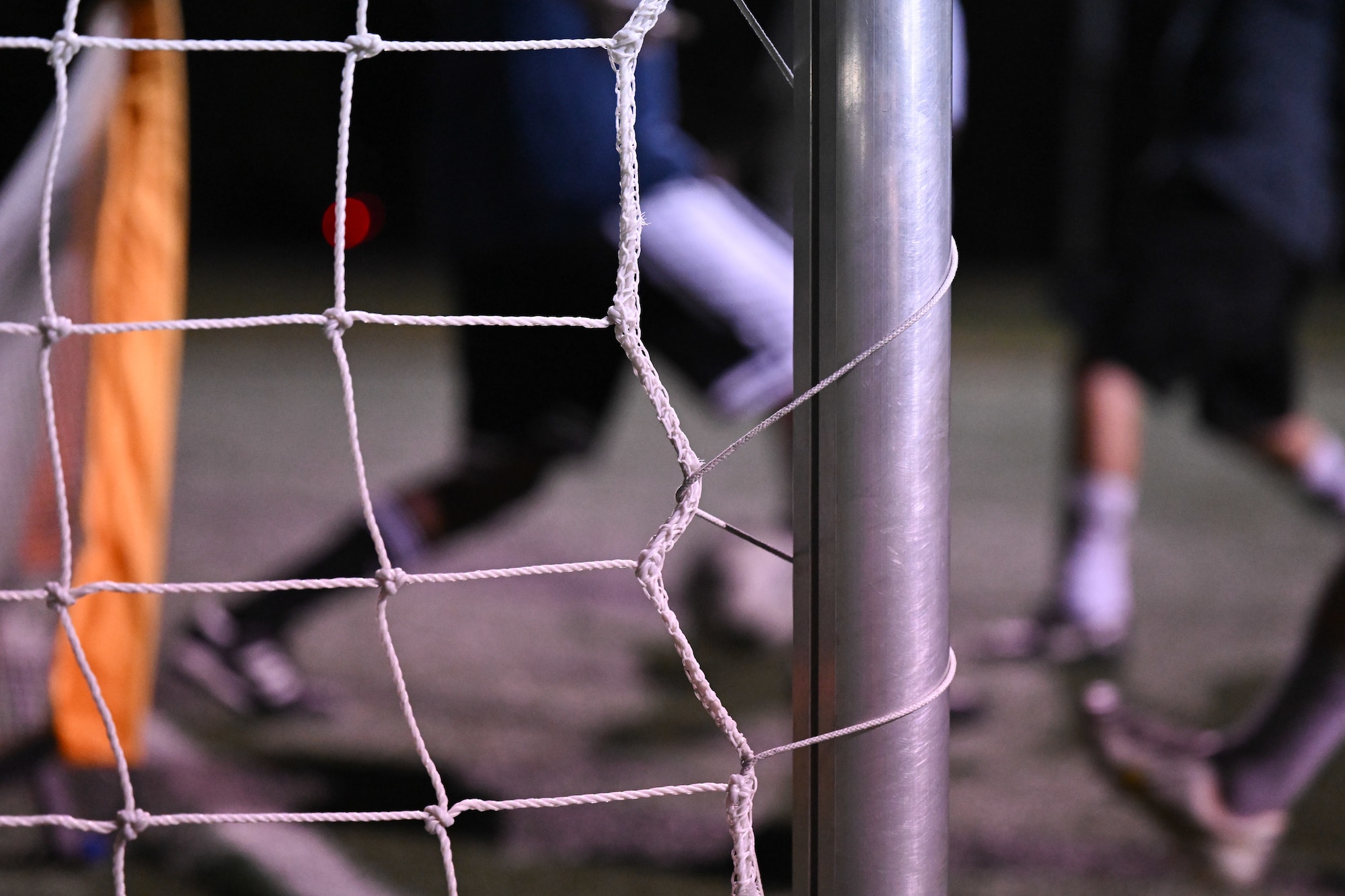 A soccer net frames players in action during a soccer pickup game at Joint Base Andrews, Md., Oct. 31, 2024. The weekly games promote fitness and camaraderie, bringing people together to build a more cohesive community. (U.S. Air Force photo by Airman 1st Class Gianluca Ciccopiedi)
