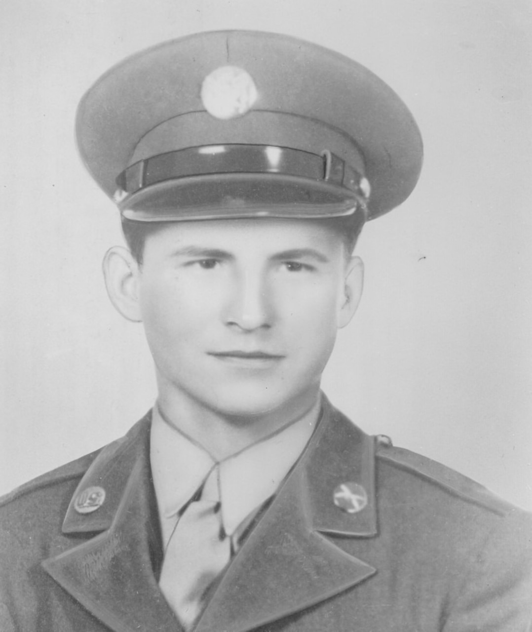 A man in cap and uniform poses for a photo.