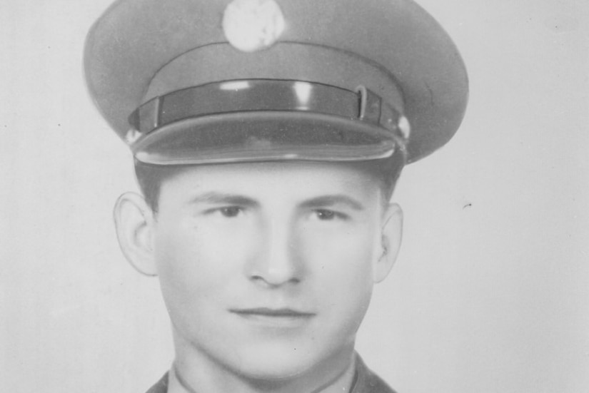 A man in cap and uniform poses for a photo.