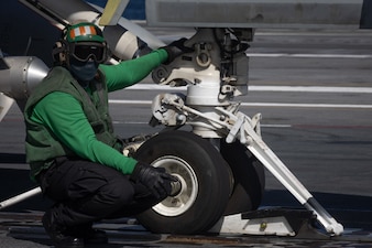 ABE2 Malcom Grandison directs an F/A-18E Super Hornet from VFA-31 aboard  USS Gerald R. Ford (CVN 78) in the Atlantic Ocean.