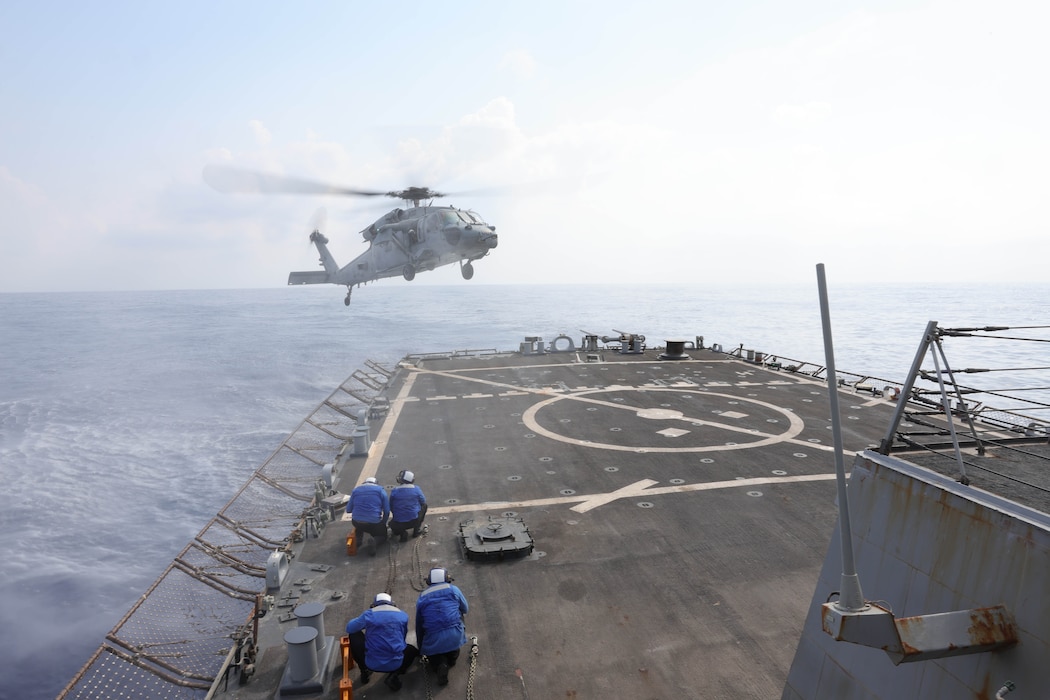 An MH-60S Sea Hawk helicopter from HSC-28 lands aboard USS Arleigh Burke (DDG 51) in the Mediterranean Sea.