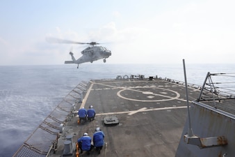 An MH-60S Sea Hawk helicopter from HSC-28 lands aboard USS Arleigh Burke (DDG 51) in the Mediterranean Sea.