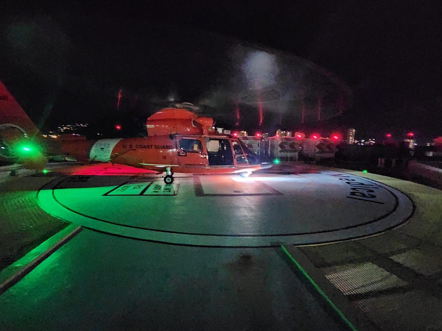 An MH-65 Dolphin helicopter crew from Coast Guard Air Station Barbers Point lands at The Queen’s Medical Center in Honolulu, Hawaii, Nov. 5, 2024. The crew medevaced a 29-year-old woman experiencing symptoms of appendicitis aboard the cruise ship Grand Princess. (U.S. Coast Guard photo, courtesy Air Station Barbers Point)