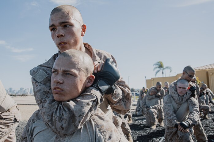 U.S. Marine Corps recruits with Kilo Company, 3rd Recruit Training Battalion, execute a figure four variation choke hold during a Marine Corps Martial Arts Program techniques test at Marine Corps Recruit Depot San Diego, California, Oct. 24, 2024. MCMAP aims to strengthen the mental and moral resiliency of recruits and Marines through realistic combative training, warrior ethos studies, and physical hardening. (U.S. Marine Corps photo by Cpl. Sarah M. Grawcock)