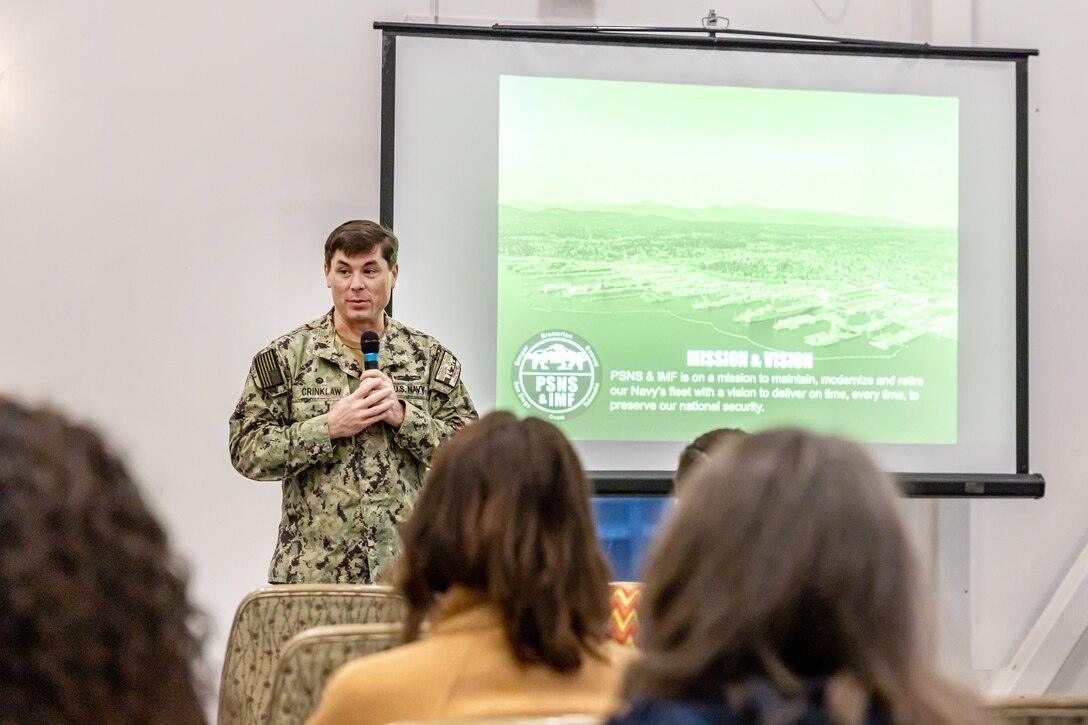 Capt. JD Crinklaw, commander, Puget Sound Naval Shipyard & Intermediate Maintenance Facility, welcomes visitors to the shipyard Oct. 21, 2024, for the annual PSNS & IMF Educator Day, in Bremerton, Washington. (U.S. Navy photo by Jeb Fach)