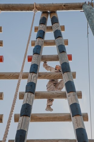 A U.S. Marine Corps recruit with Fox Company, 2nd Recruit Training Battalion, climbs an obstacle during a confidence course training event at Marine Corps Recruit Depot San Diego, California, Oct. 24, 2024. The confidence course challenges recruits physically and mentally through obstacles that require confidence in their strength, balance, and determination. (U.S. Marine Corps photo by Cpl. Sarah M. Grawcock)