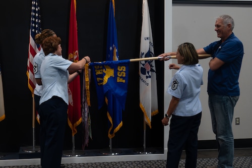 U.S. Air Force Col. Angelina Maguinness, 17th Training Wing commander, pins a streamer on to the 17th Force Support Squadron guidon staff during the 3rd Quarterly Awards at the Powell Event Center, Goodfellow Air Force Base, Texas, Nov. 1, 2024. The 17th FSS won the 17th TRW Spirit Award of the Quarter. (U.S. Air Force photo by Airman 1st Class Brian Lummus)