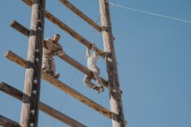U.S. Marine Corps recruits with Fox Company, 2nd Recruit Training Battalion, climb up an obstacle during a confidence course training event at Marine Corps Recruit Depot San Diego, California, Oct. 24, 2024. The confidence course challenges recruits physically and mentally through obstacles that require confidence in their strength, balance, and determination. (U.S. Marine Corps photo by Cpl. Sarah M. Grawcock)