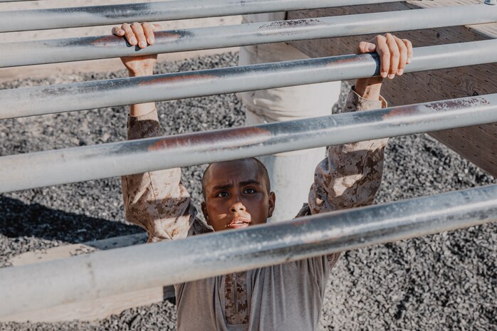 A U.S. Marine Corps recruit with Fox Company, 2nd Recruit Training Battalion, navigates through an obstacle during a confidence course training event at Marine Corps Recruit Depot San Diego, California, Oct. 24, 2024. The confidence course challenges recruits physically and mentally through obstacles that require confidence in their strength, balance, and determination. (U.S. Marine Corps photo by Cpl. Sarah M. Grawcock)