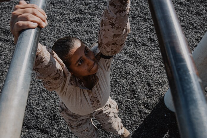 A U.S. Marine Corps recruit with Fox Company, 2nd Recruit Training Battalion, navigates through an obstacle during a confidence course training event at Marine Corps Recruit Depot San Diego, California, Oct. 24, 2024. The confidence course challenges recruits physically and mentally through obstacles that require confidence in their strength, balance, and determination. (U.S. Marine Corps photo by Cpl. Sarah M. Grawcock)