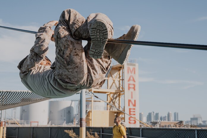 A U.S. Marine Corps recruit with Fox Company, 2nd Recruit Training Battalion, navigates through an obstacle during a confidence course training event at Marine Corps Recruit Depot San Diego, California, Oct. 24, 2024. The confidence course challenges recruits physically and mentally through obstacles that require confidence in their strength, balance, and determination. (U.S. Marine Corps photo by Cpl. Sarah M. Grawcock)