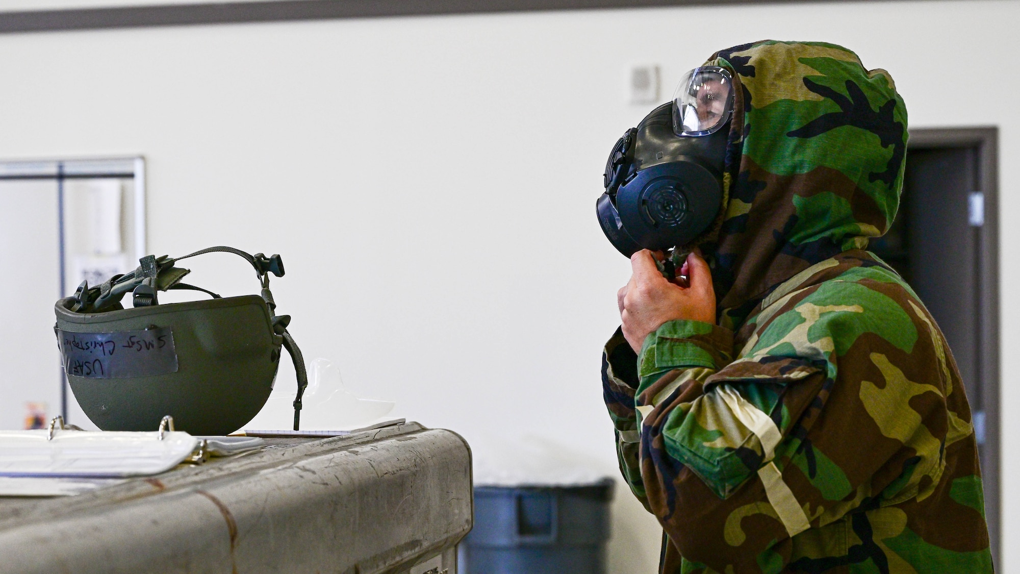 A Reserve Citizen Airman with the 910th Airlift Wing quickly dawns his mission-oriented protective posture gear before a simulated aerial attack, Nov. 3, 2024, during Combat Readiness Exercise Buckeye II at Youngstown Air Reserve Station, Ohio.