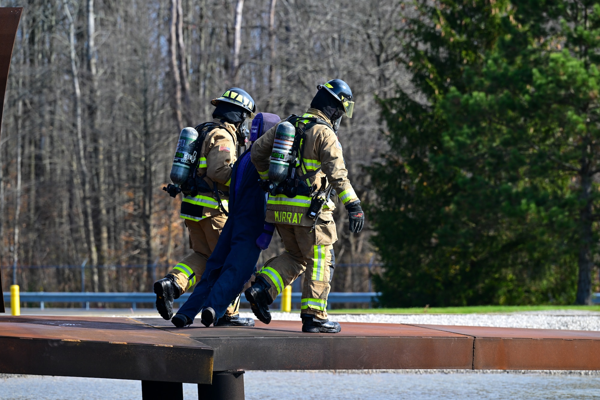 Firefighters assigned to the 910th Civil Engineer Squadron rescue a staged casualty on the wing of a burning aircraft simulation, Nov. 4, 2024, during Combat Readiness Exercise Buckeye II at Youngstown Air Reserve Station, Ohio.