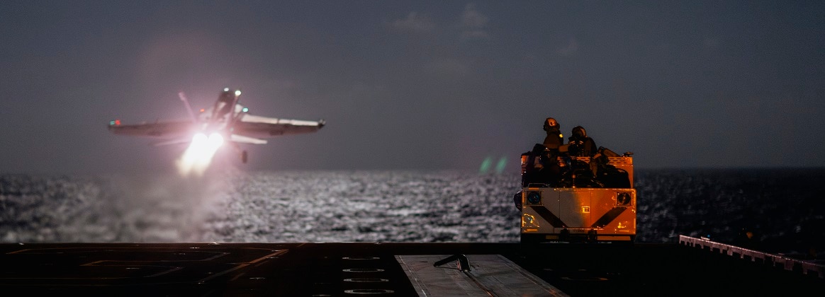 Sailors, assigned to air department’s crash and salvage division, stand watch on the flight deck of Nimitz-class aircraft carrier USS George Washington (CVN 73) as an F/A-18E Super Hornet, attached to the Royal Maces of Strike Fighter Squadron (VFA) 27, takes off while underway in the Pacific Ocean, Oct. 15, 2024.