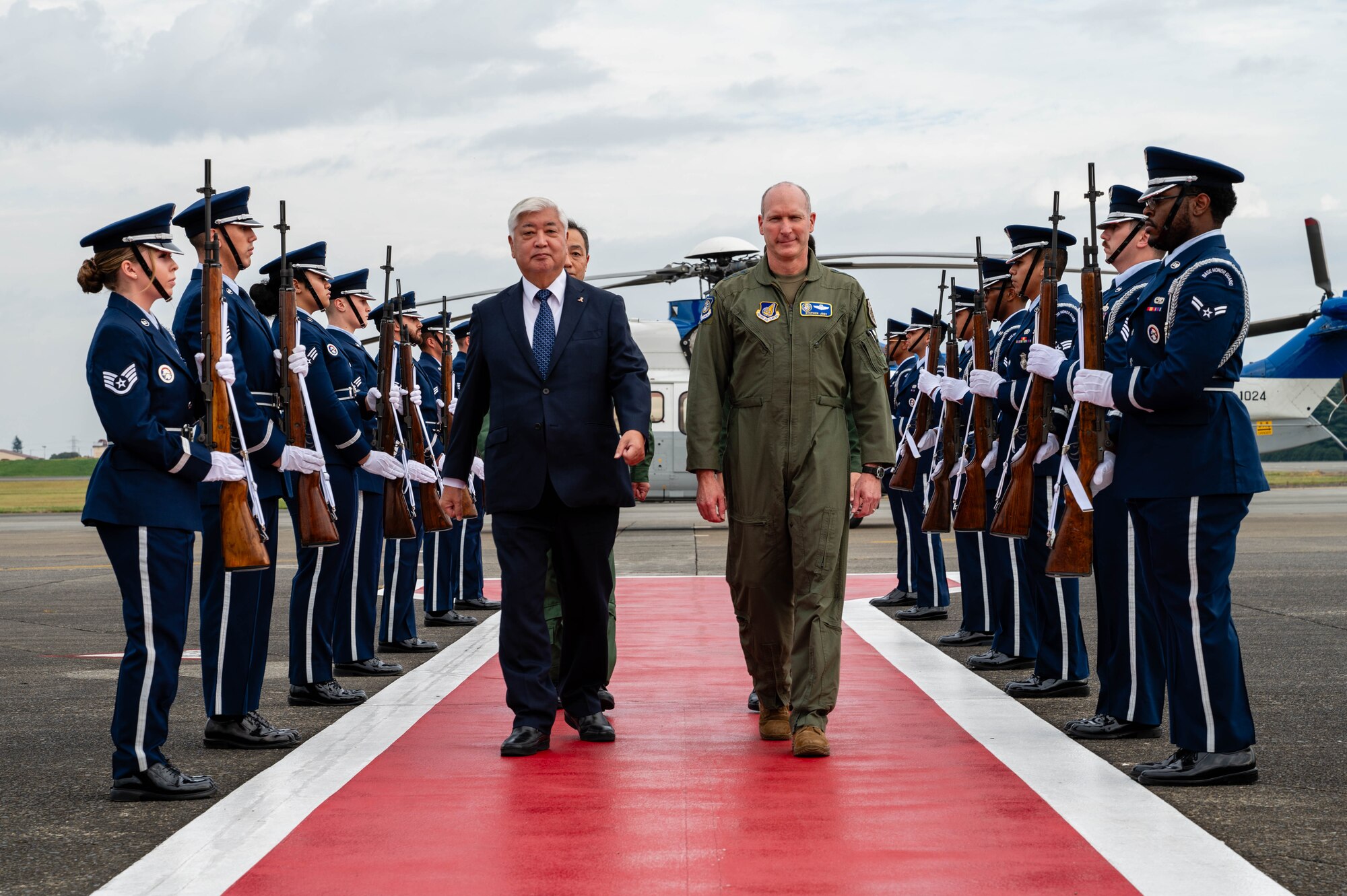 U.S. Air Force Lt. Gen. Stephen Jost, U.S. Forces Japan and Fifth Air Force commander, and Honorable Gen Nakatani, Japan's Minister of Defense, walk through an honor cordon at Yokota Air Base, Japan.