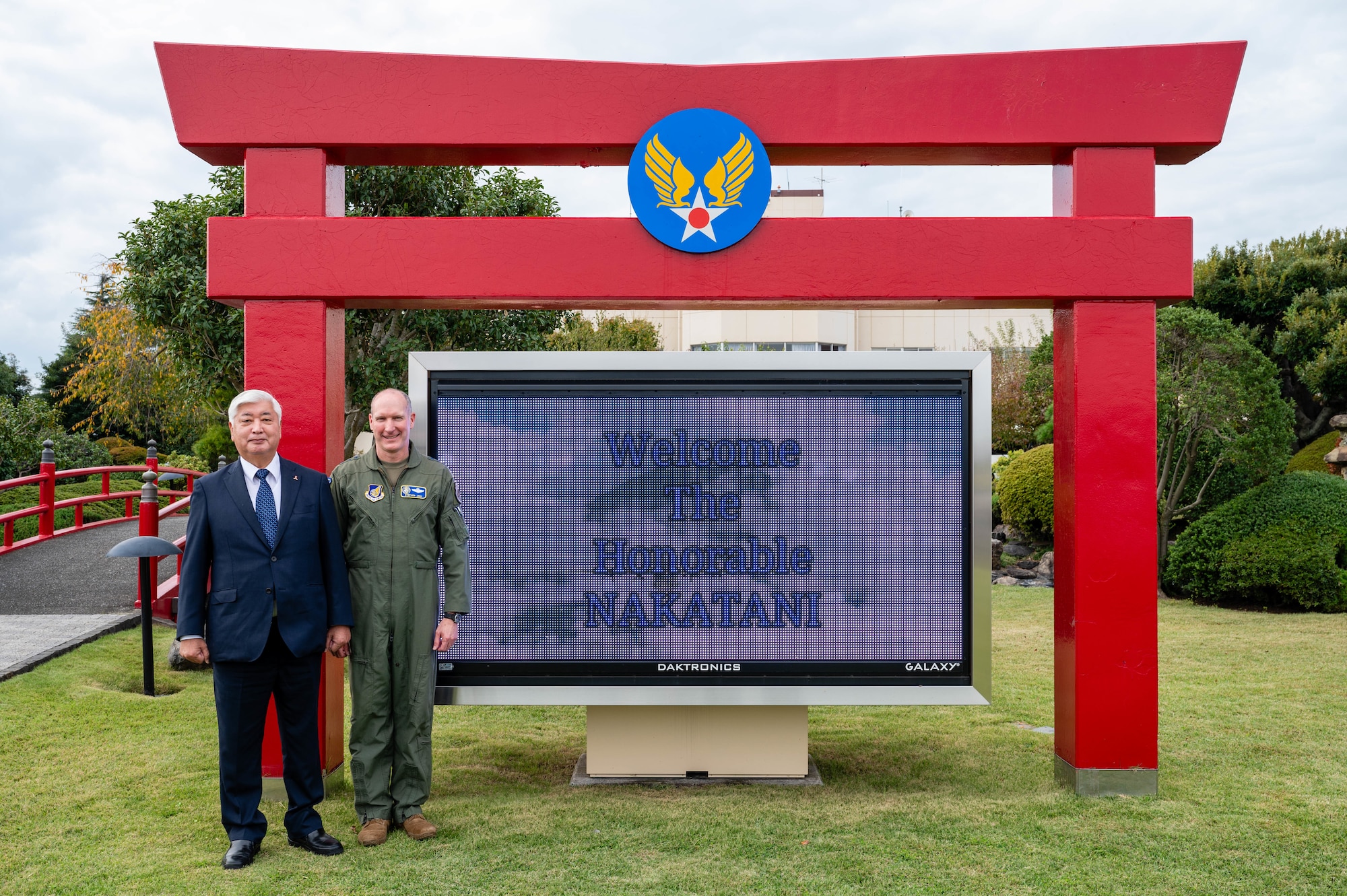 U.S. Air Force Lt. Gen. Stephen Jost, U.S. Forces Japan and Fifth Air Force commander, and Honorable Gen Nakatani, Japan's Minister of Defense, pose for a photo in front of the distinguished visitor garden marquee at Yokota Air Base, Japan.