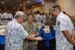 LUMUT, Malaysia (Nov, 5, 2024) U.S. Navy Capt. Pasit Somboonpakron, defense attché to U.S. Embassy Kuala Lumpur, middle, speaks with members of the Royal Malaysian Navy at the closing ceremony of Cooperation Afloat Readiness and Training (CARAT) Malaysia 2024, Nov. 5. CARAT Malaysia 2024 is a biennial exercise that seeks to enhance collaboration focused on shared maritime security challenges in the region. In its 30th year, CARAT 2024 highlights the longstanding role of regular collaboration as a credible venue for regional Allies and partners to address shared maritime security priorities. (U.S. Navy photo by Mass Communication Specialist 1st Class Hannah Fry/Released)