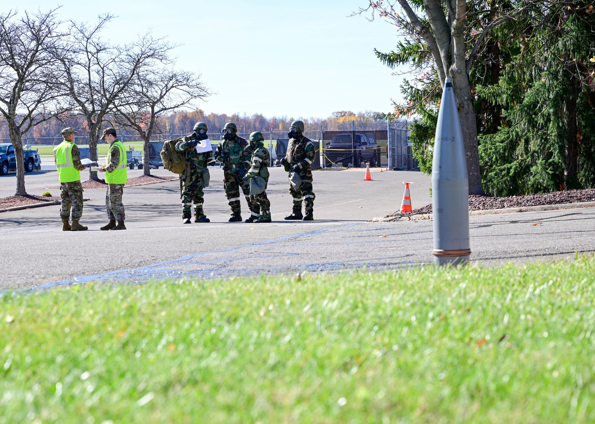 A 910th Airlift Wing post-attack reconnaissance team spots unexploded ordnance during their area sweep, Nov. 3, 2024, while wing inspection team members watch during Combat Readiness Exercise Buckeye II at Youngstown Air Reserve Station, Ohio.