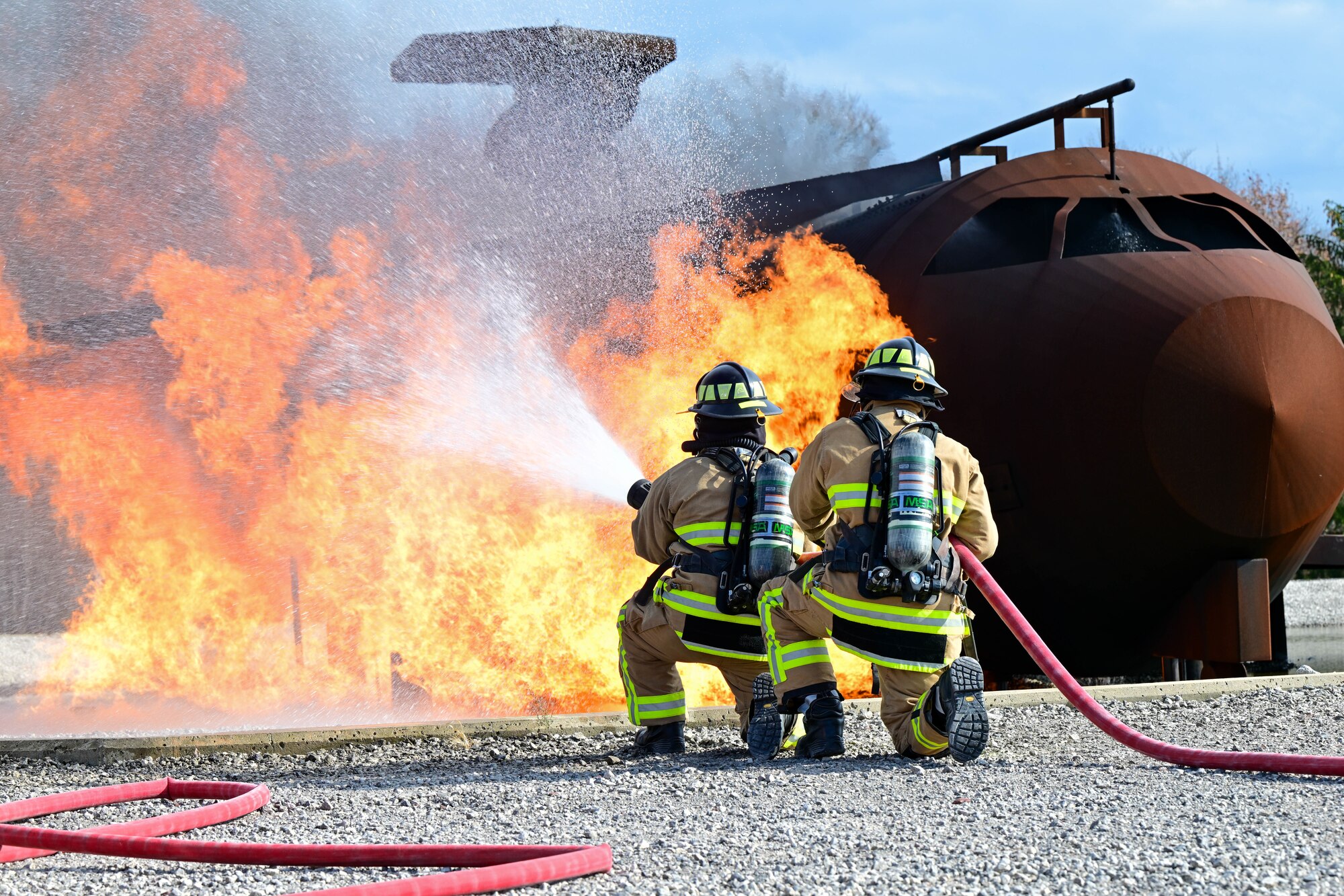 Firefighters assigned to the 910th Civil Engineer Squadron fight a simulated aircraft fire, Nov. 4, 2024, during Combat Readiness Exercise Buckeye II at Youngstown Air Reserve Station, Ohio.