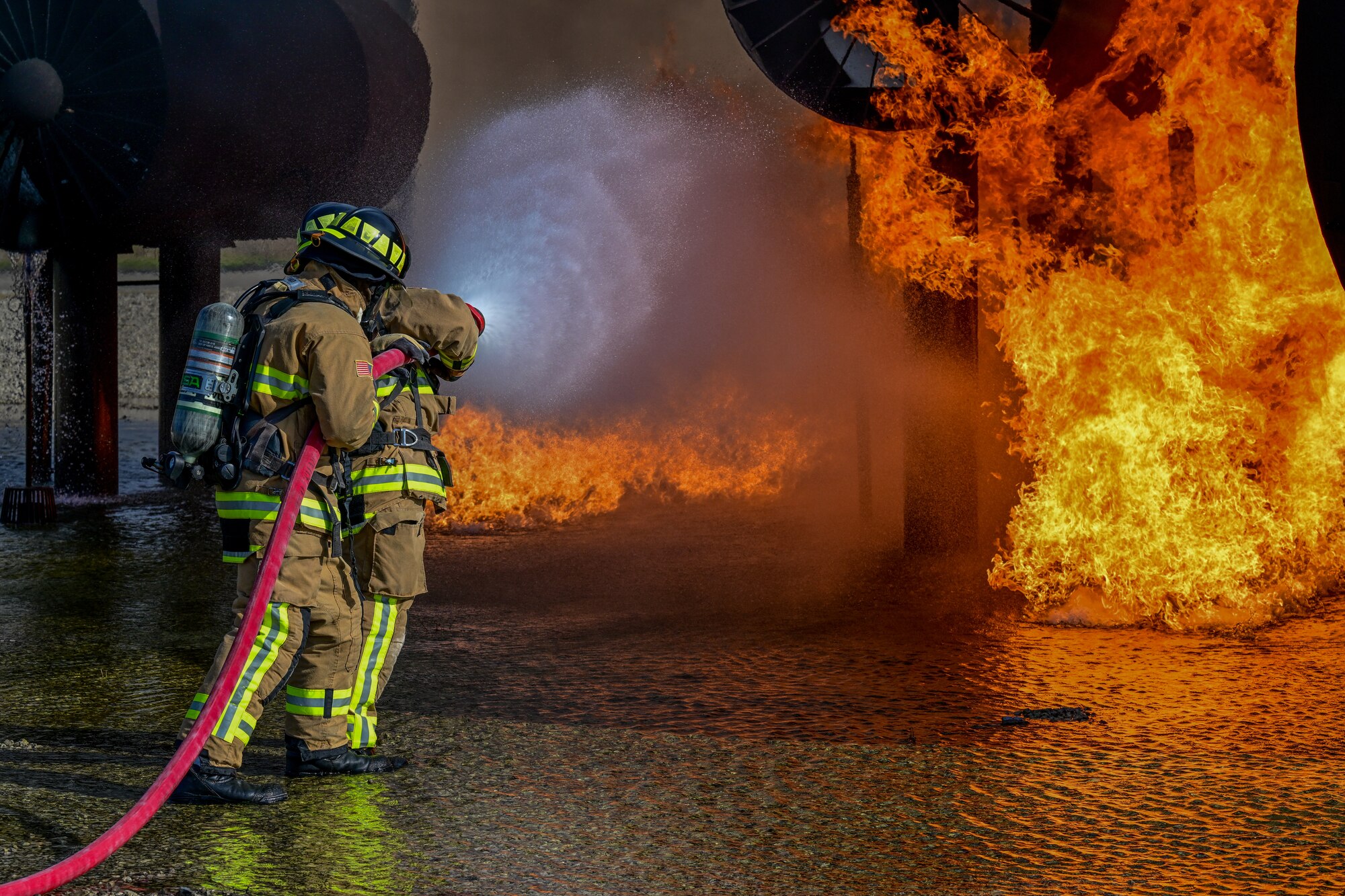 Firefighters assigned to the 910th Civil Engineer Squadron fight a simulated aircraft fire, Nov. 4, 2024, during Combat Readiness Exercise Buckeye II at Youngstown Air Reserve Station, Ohio.