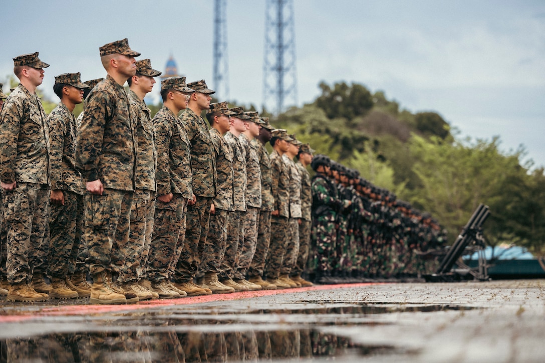 U.S. Marines with Marine Rotational Force-Southeast Asia, I Marine Expeditionary Force, and Indonesian marines with 10th Marine Infantry Battalion, Indonesian Korps Marinir, stand in formation during the Keris Marine Exercise (MAREX) 2024 Opening Ceremony at Yonif 10 Marinir, Batam, Indonesia, Nov. 6, 2024. Keris MAREX is a bilateral exercise conducted by the U.S. Marine Corps and Korps Marinir Republik Indonesia, or Indonesian Marine Corps, to strengthen relationships as military partners and increase interoperability among participating forces in the advancement of a Free and Open Indo-Pacific. MRF-SEA is a rotational unit derived from elements of I Marine Expeditionary Force executing a U.S. Marine Corps Forces, Pacific operational model that involves training events and exchanges with partner military subject matter experts, promotes security goals with Allied and partner nations, and ensures a persistent I MEF presence west of the International Date Line. (U.S. Marine Corps photo by Sgt. Shaina Jupiter)