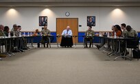 Secretary of the Air Force sits and eats lunch with Airmen