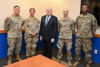 Airmen pose with the Secretary of the Air Force