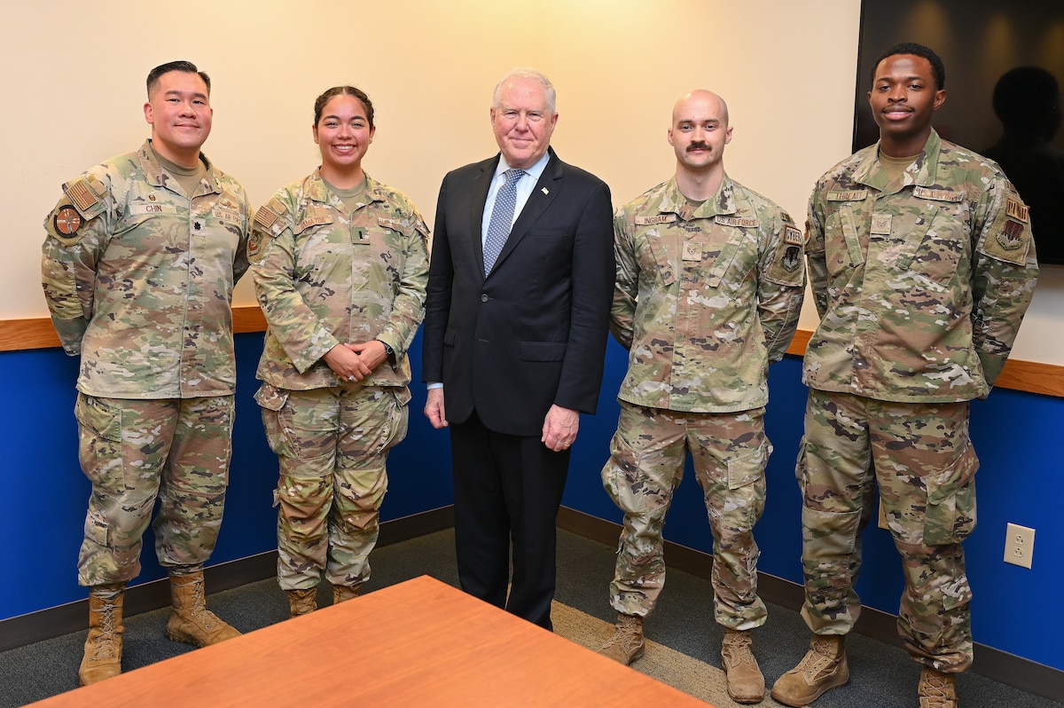 Airmen pose with the Secretary of the Air Force