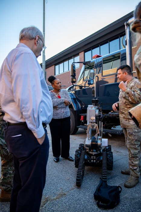 Photo shows people standing around robot