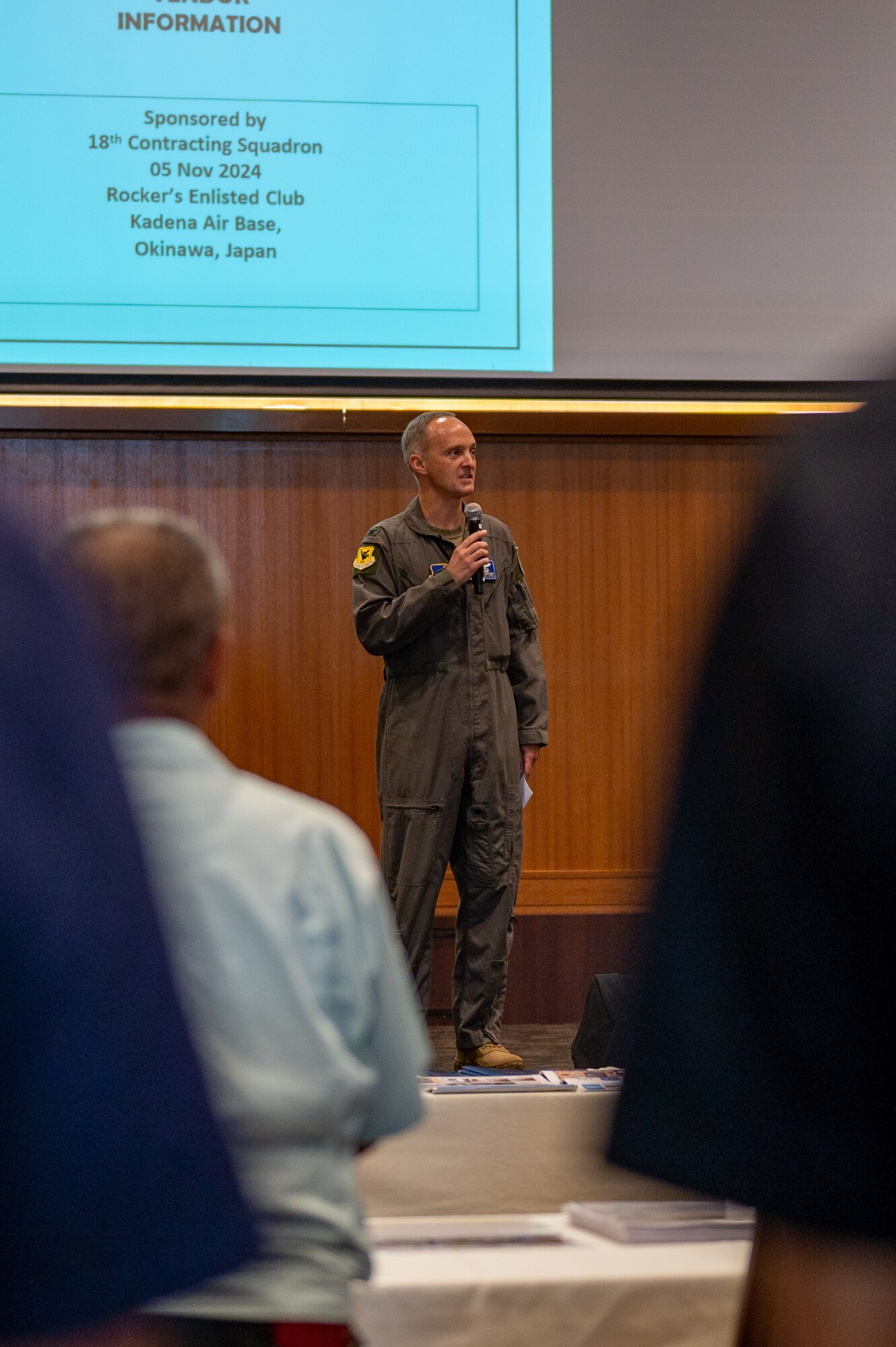 Military member speaks into a mircophone
