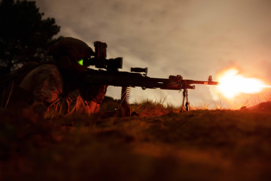 Marine Corps Capt. Coby Fisher fires an M240B machine gun during a live-fire exercise at Camp Schwab, Okinawa, Japan, Sept. 30, 2024.