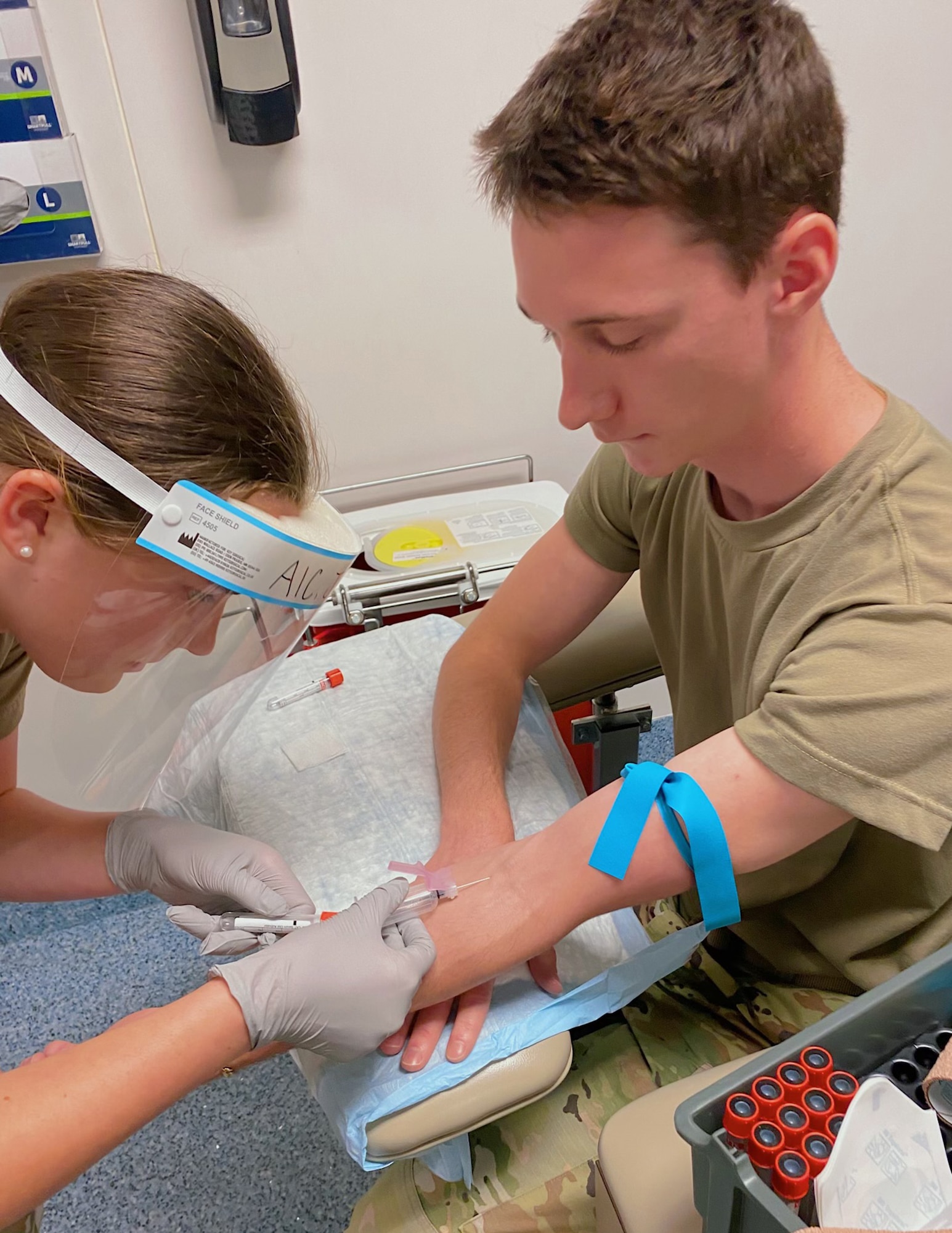 U.S. Air Force Airman 1st Class Bridget Johnson draws blood on her classmate in Fort Sam Houston, Texas, April 19, 2022.