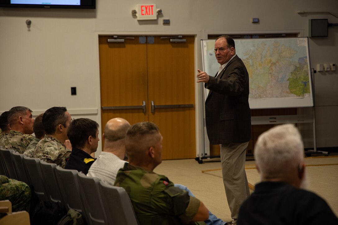 Mr. Daniel Kelly gives a brief during a multination amphibious conference with NATO allied service members at Marine Corps Base Camp Lejeune, Oct. 2024. The multi nation conference facilitated U.S. Marine and NATO allies and partners in planning, integrating and informing amphibious and maritime operations. (U.S. Marine Corps photo by Cpl. Aziza Kamuhanda)