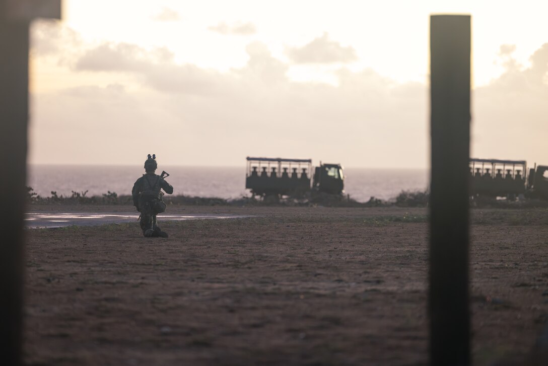 A Dutch Marine with Marine Squadron Carib holds security while personnel carriers arrive as part of a raid during the final exercise of Tres Kolos 24 in Sint Nicolaas, Aruba, Oct. 25, 2024. U.S. Marines with Golf Company, 2d Battalion, 2d Marine Regiment, 2d Marine Division conducted a deployment for training to Aruba to conduct small-unit training while building camaraderie with the Royal Netherlands Marine Corps, a NATO ally and routine training partner. (U.S. Marine Corps photo by Cpl. Antonino Mazzamuto)