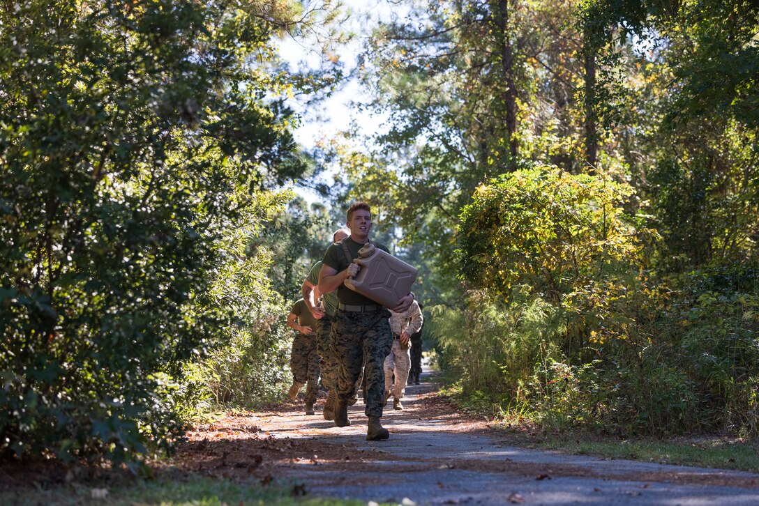 U.S. Marines with Combat Logistics Battalion 26, Combat Logistics Regiment 27, 2nd Marine Logistics Group, carry water jugs during a battalion field meet on Camp Lejeune, North Carolina, Oct. 25, 2024. The field meet consisted of various athletic events to promote cohesion, camaraderie and physical fitness within the unit.(U.S. Marine Corps photo by Sgt. Mary Kohlmann)