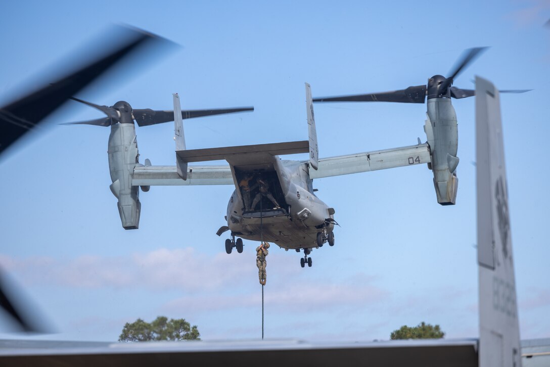 U.S. Marine Corps Capt. Ryan Barber, a platoon commander with Marine Corps Security Force Regiment rappels out of a MV-22 Osprey from Marine Medium Tiltrotor Squadron 263 during Expeditionary Operations Training Group helicopter rope suspension techniques (HRST) training on Marine Corps Base Camp Lejeune, North Carolina, Oct. 28, 2024. HRST training equips Marines with the skills to rappel and fast rope from an aircraft in order to remain mission ready. (U.S. Marine Corps photo by Cpl. Alexander Lesko)