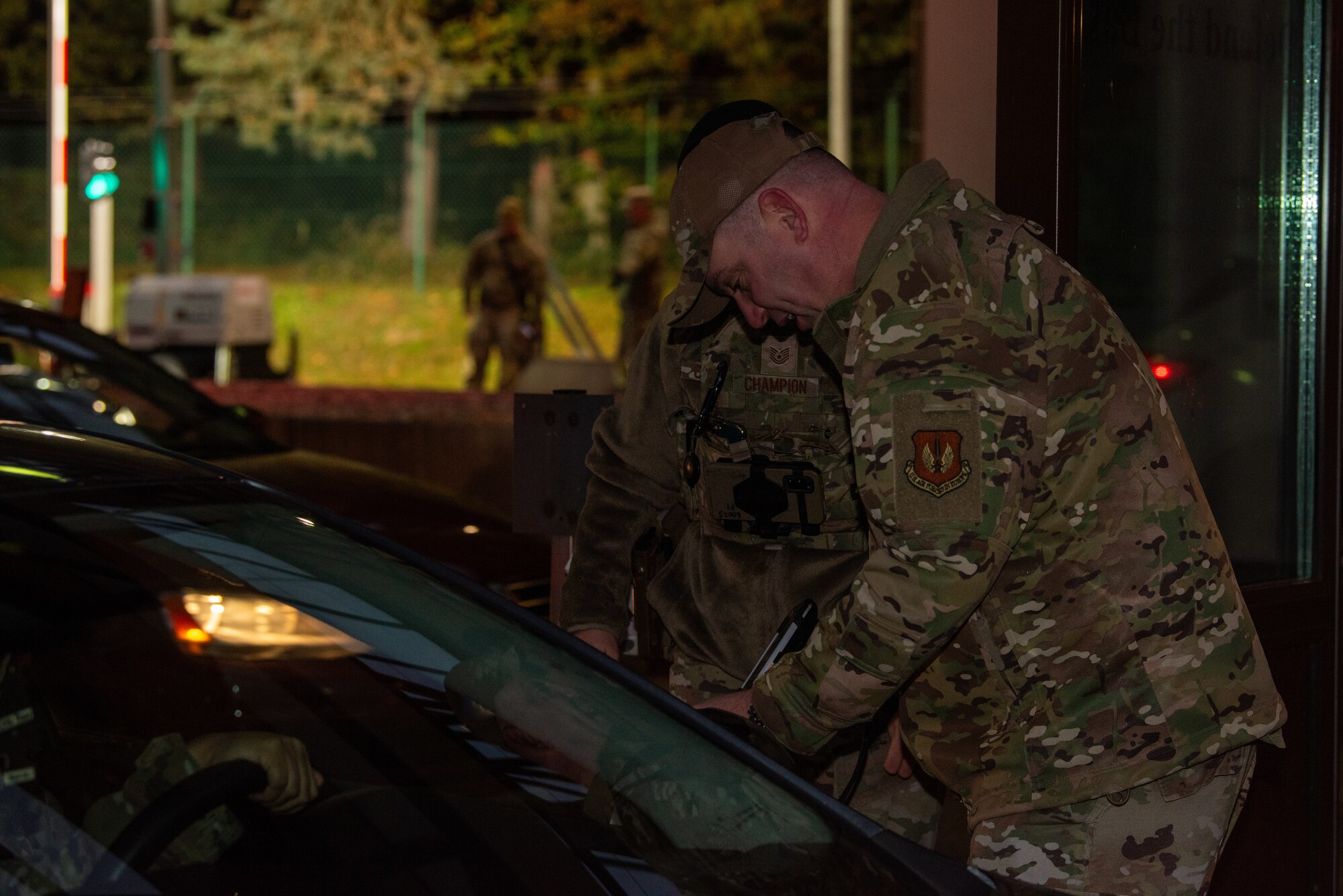 Command Chief scans IDs at gate.