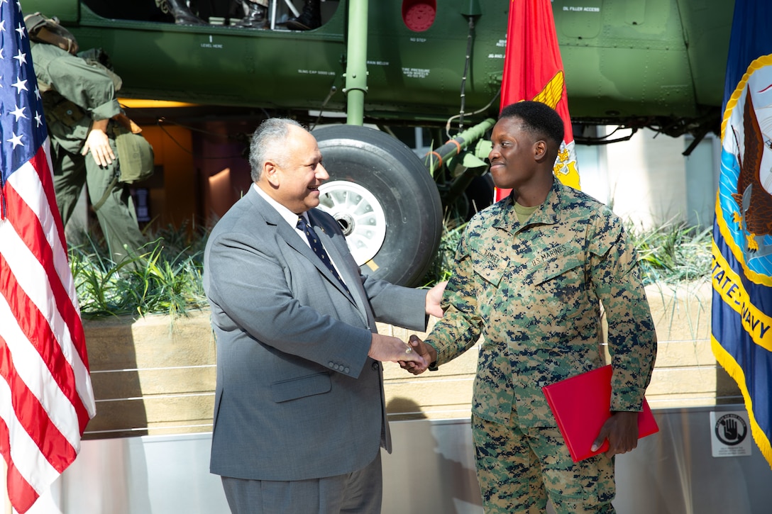 U.S. Marine Corps Lance Cpl. Anthony C. Ramsey Jr., a combat graphics specialist, is promoted to the rank of corporal by the Secretary of the Navy (SECNAV) Carlos Del Toro during a visit to the National Museum of the Marine Corps.