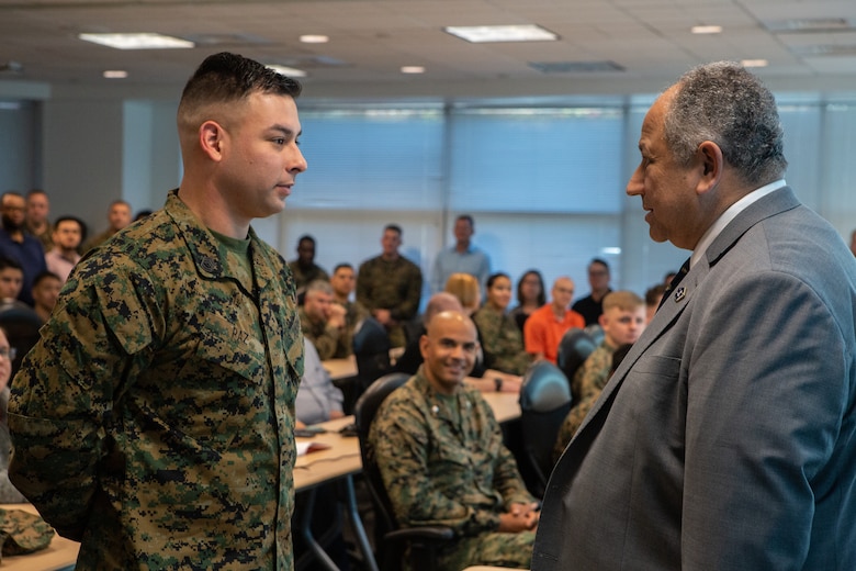 The Secretary of the Navy (SECNAV) Carlos Del Toro recognizes Gunnery Sgt. Antonio V. Paz, a recruiter with 1st Marine Corps District Headquarters, for winning recruiter of the year during a visit to Marine Corps Base Quantico