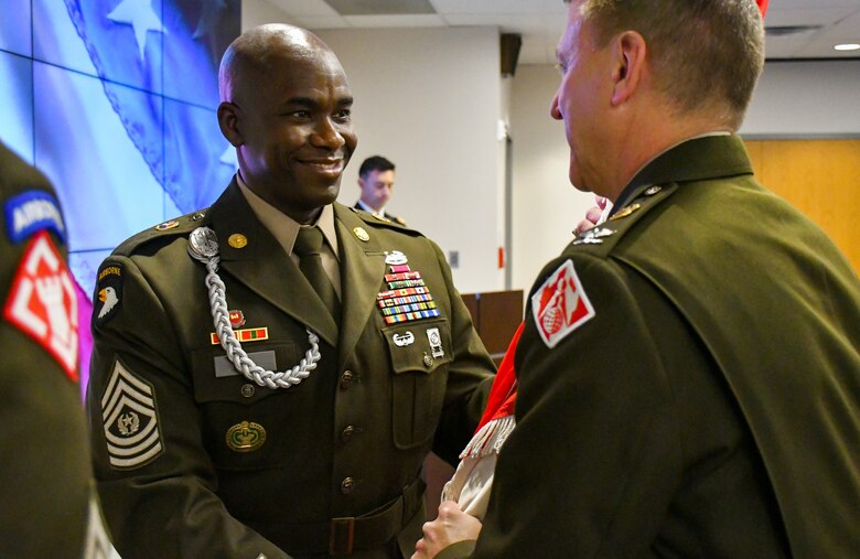 U.S. Army Command Sgt. Maj. Clifton D. Morehouse passes the colors to Col. Craig S. Baumgartner, U.S. Army Corp of Engineers Transatlantic Division commander, as he relinquished responsibility to Command Sgt. Maj. Michael Arroyo during a Change of Responsibility ceremony in Winchester, Va., Nov. 7.