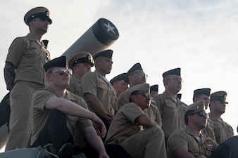 U.S. Navy Sailors with Arleigh Burke-class guided-missile destroyer USS John Basilone (DDG 122) pose for a group photo aboard the USS New Jersey (BB 62) in Camden, New Jersey, Nov. 6, 2024.