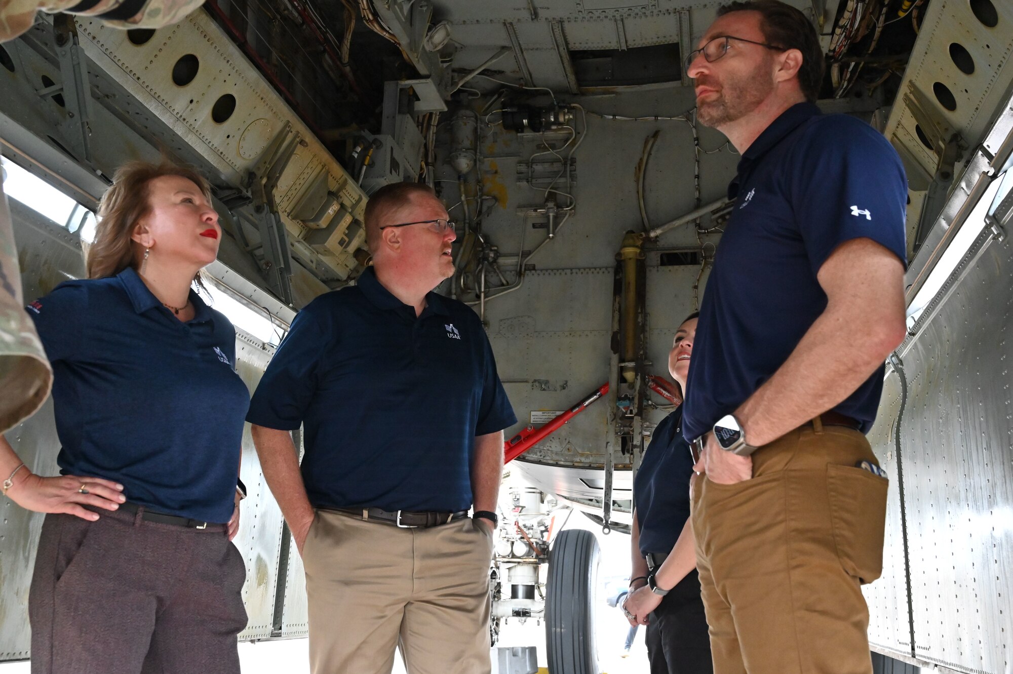 Three USAA executives stand in the bomb bay of a B-52  Stratofortress during a static tour of the jet.