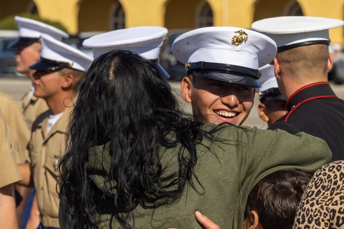 A new U.S. Marine from Delta Company, 1st Recruit Training Battalion, is greeted by a guest after a graduation ceremony at Marine Corps Recruit Depot San Diego, California, Nov. 1, 2024. Graduation took place at the completion of the 13-week transformation, which included training for drill, marksmanship, basic combat skills, and Marine Corps customs and traditions. (U.S. Marine Corps photo by Cpl. Alexander O. Devereux)