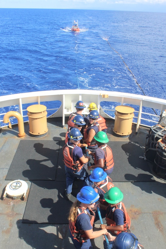 Coast Guard Cutter Reliance (WMEC 615) deck crew members handle line during towing operations with the cutter’s small boat, Oct. 11, 2024, while at sea in the Windward Passage. Reliance’s crew completed a 60-day patrol in the Seventh Coast Guard District area of responsibility to conduct maritime safety and security missions. (U.S. Coast Guard photo by Ensign Sarah Kaleta)