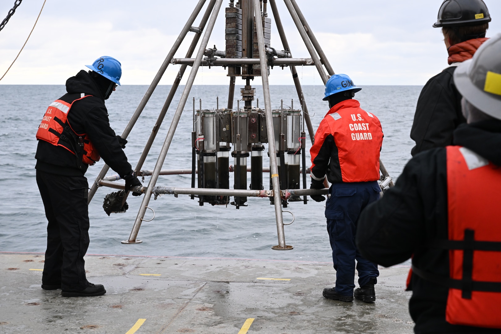 U.S. Coast Guard Cutter Healy (WAGB 20) crewmembers retrieve a muti-core device following deployment in the Chukchi Sea, Oct. 26, 2024. The embarked science team uses the multi-core device to collect water and sediment samples from the sea floor. U.S. Coast Guard photo by Senior Chief Petty Officer Matt Masaschi.