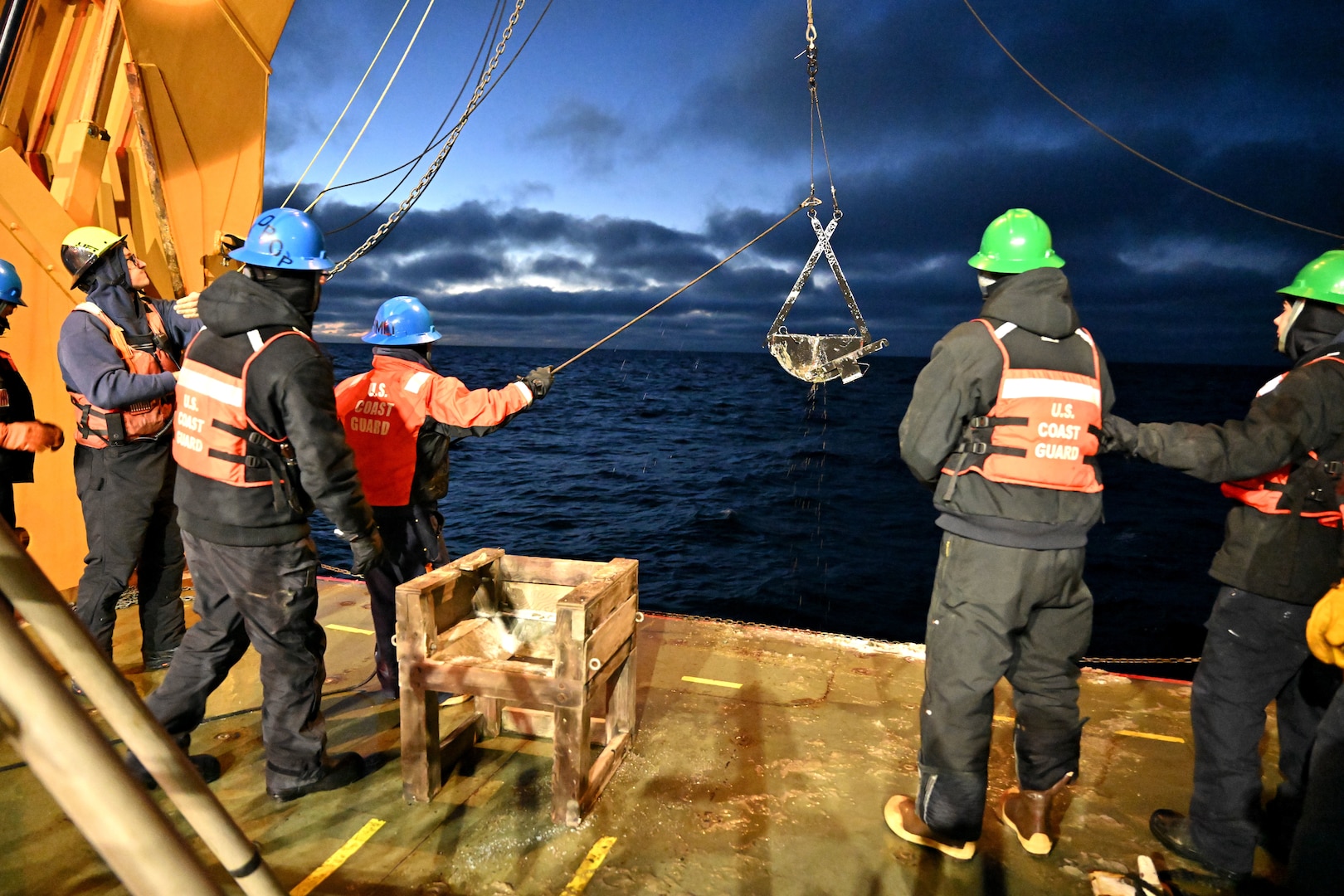 U.S. Coast Guard Cutter Healy (WAGB 20) crewmembers prepare to deploy a Van Veen grab sampler in the Chukchi Sea, Oct. 27, 2024. Healy hosted junior scientists from a variety of institutions during the second phase of the Arctic deployment, supporting the U.S. National Science Foundation-funded Polar Early Career Scientist Training project, with contributions from NOAA and the Coast Guard providing training and research opportunities in the operational areas of the Chukchi and Beaufort seas and within the marginal ice zone. U.S. Coast Guard photo by Senior Chief Petty Officer Matt Masaschi.