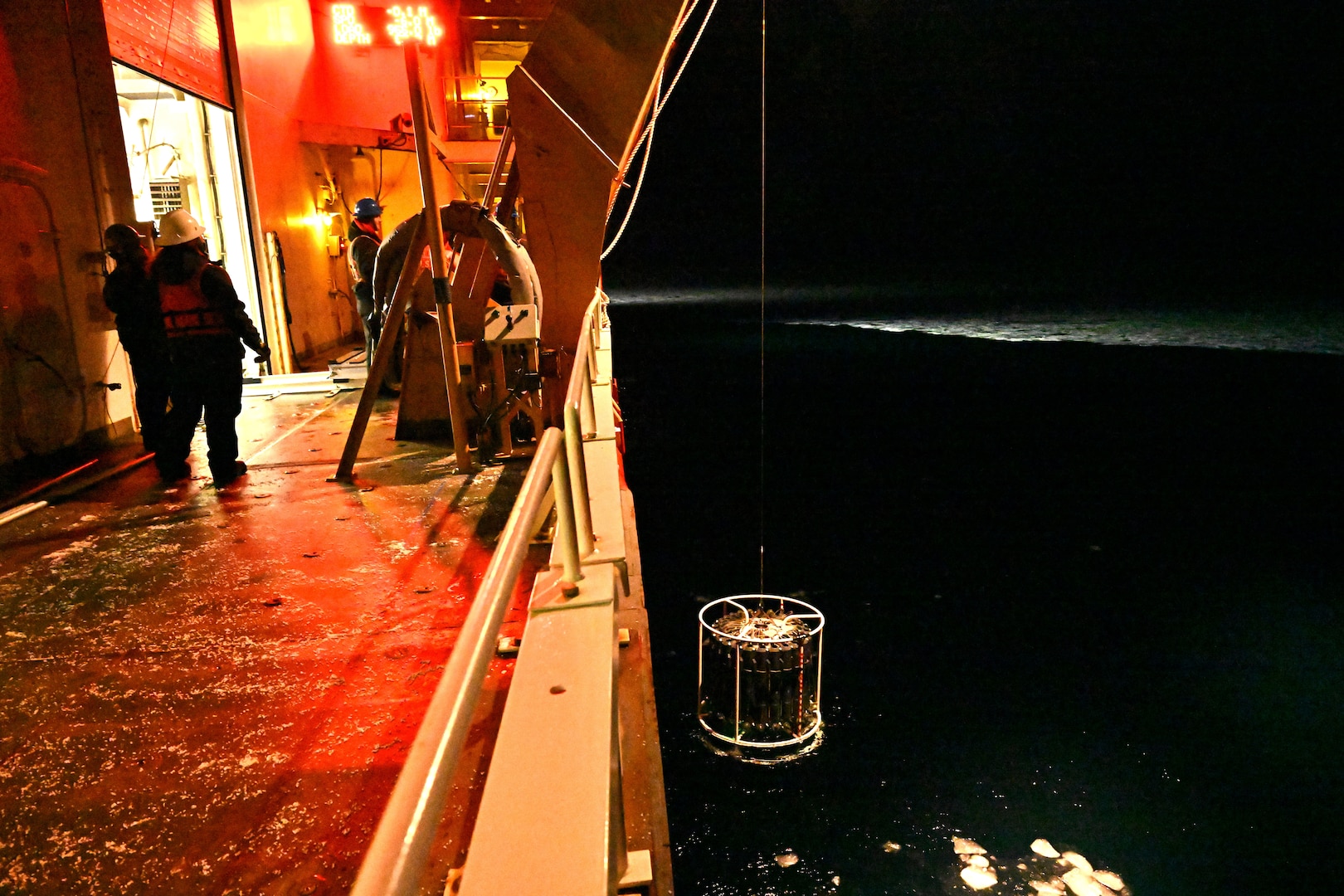 U.S. Coast Guard Cutter Healy (WAGB 20) crewmembers retrieve a Conductivity, Temperature, and Depth (CTD) instrument from the Chukchi Sea, Oct. 27, 2024. Healy’s crew has supported the embarked scientists by deploying equipment and instruments for collecting water samples and data throughout their Arctic deployment. U.S. Coast Guard photo by Senior Chief Petty Officer Matt Masaschi.