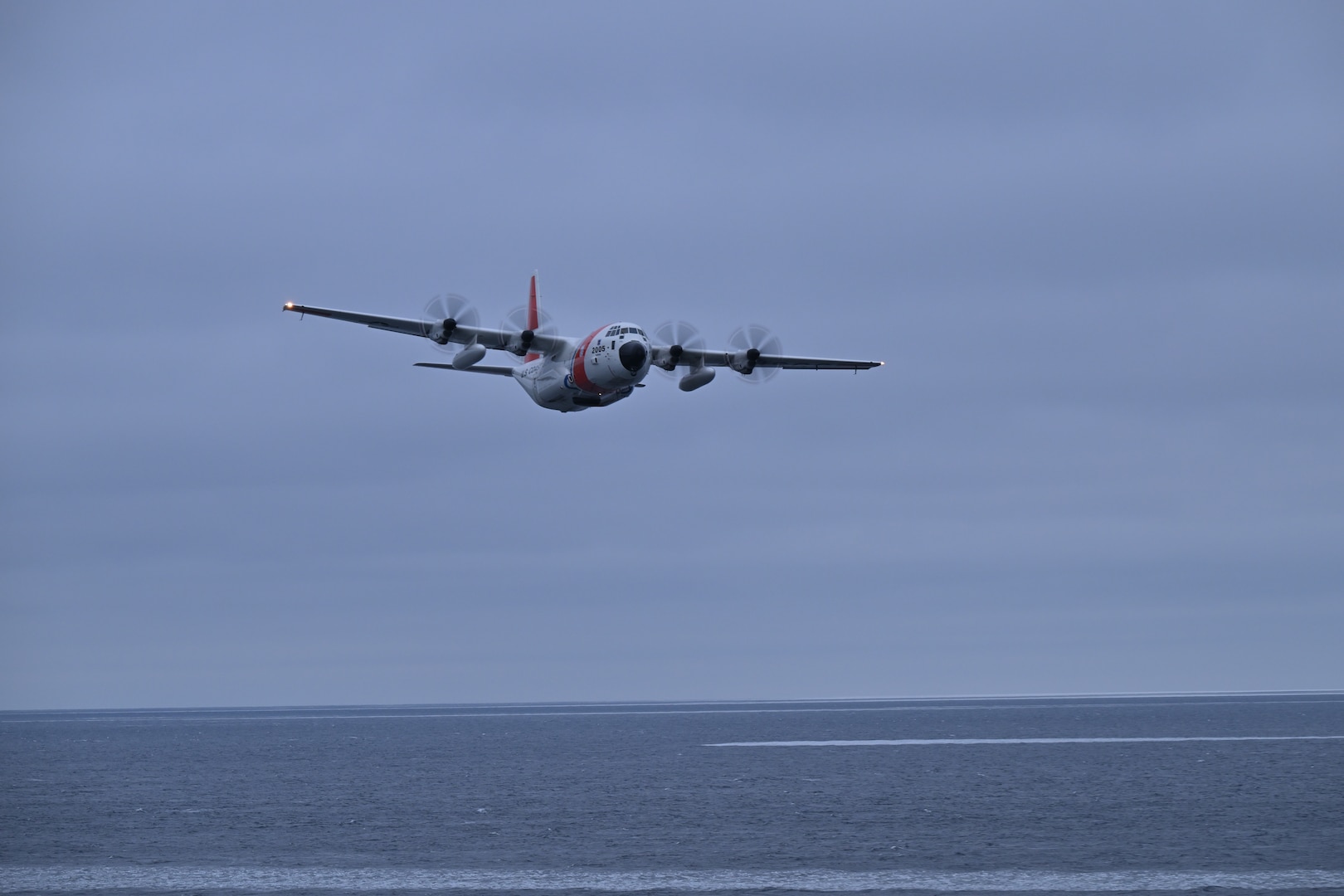 A U.S. Coast Guard Air Station Kodiak HC-130J approaches the U.S. Coast Guard Cutter Healy (WAGB 20) while Healy operates in the Chukchi Sea, Oct. 30, 2024. Healy is the Coast Guard's only icebreaker explicitly designed to support research and provides high-latitude U.S. presence and access to areas for the scientific community challenging for most research vessels to reach. U.S. Coast Guard photo by Senior Chief Petty Officer Matt Masaschi.